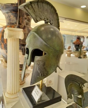 Life Size Bronze helmet with owl of Athena on cheek plate on black marble bas