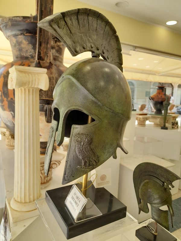 Life Size Bronze helmet with owl of Athena on cheek plate on black marble bas