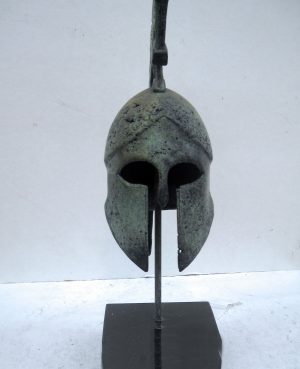 Small bronze helmet on marble base